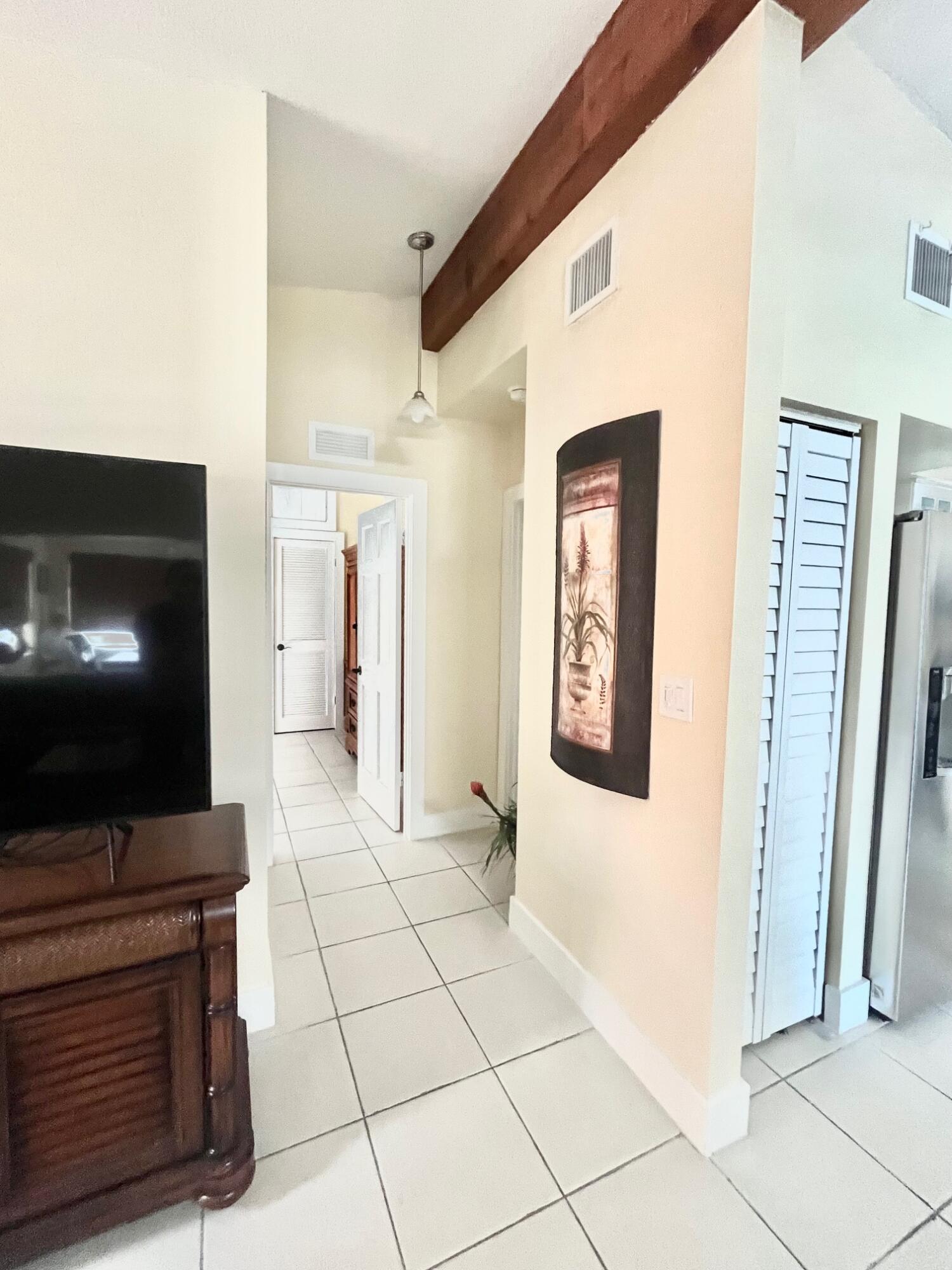 101620 Overseas Highway, Unit 5N Key Largo, FL 33037 - Photo 9 of 28 a view of a hallway with furniture and staircase