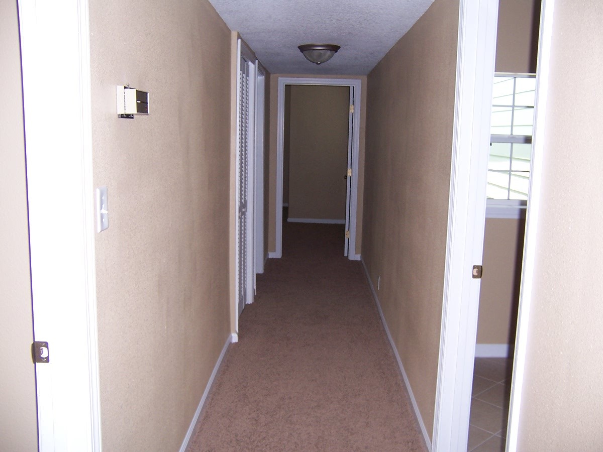 4234 Spring Park Road Jacksonville, FL 32207 - Photo 16 of 20 a view of a hallway with wooden floor