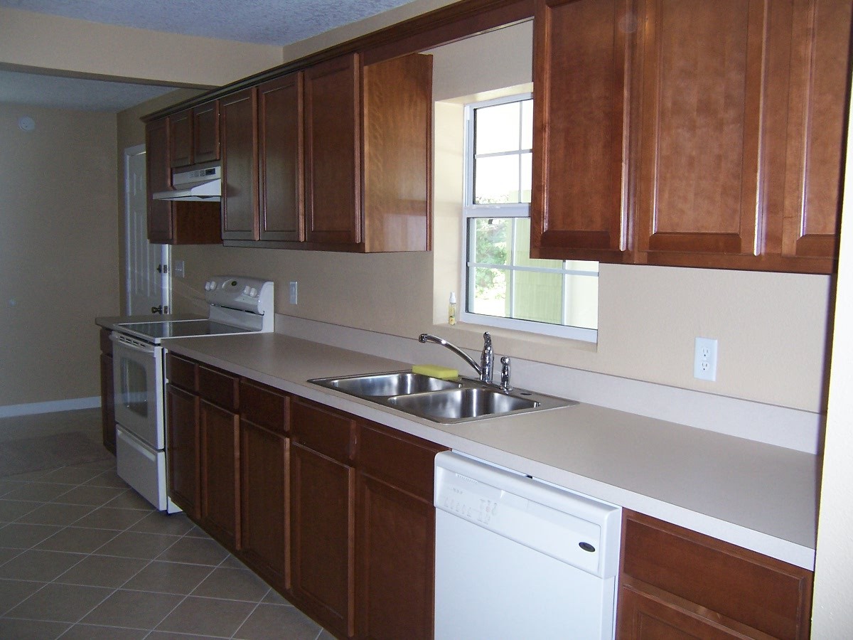 4234 Spring Park Road Jacksonville, FL 32207 - Photo 9 of 20 a kitchen with a sink cabinets and window