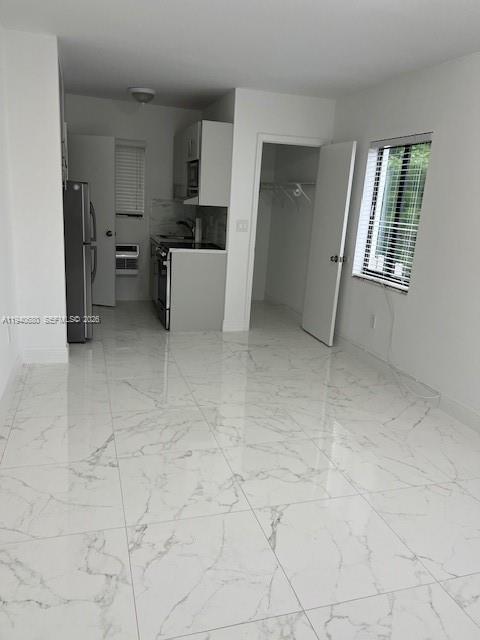 a view of kitchen with furniture and window