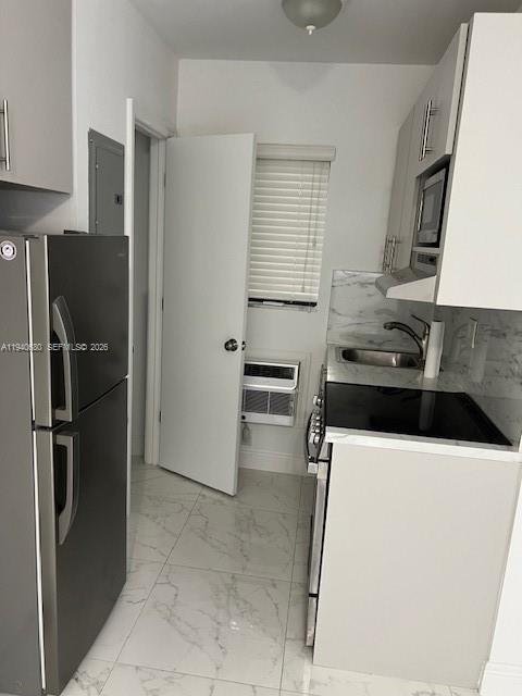 625 Southwest 5th Avenue, Unit 1 Miami, FL 33130 - Photo 3 of 5 a kitchen with stainless steel appliances a refrigerator sink and stove