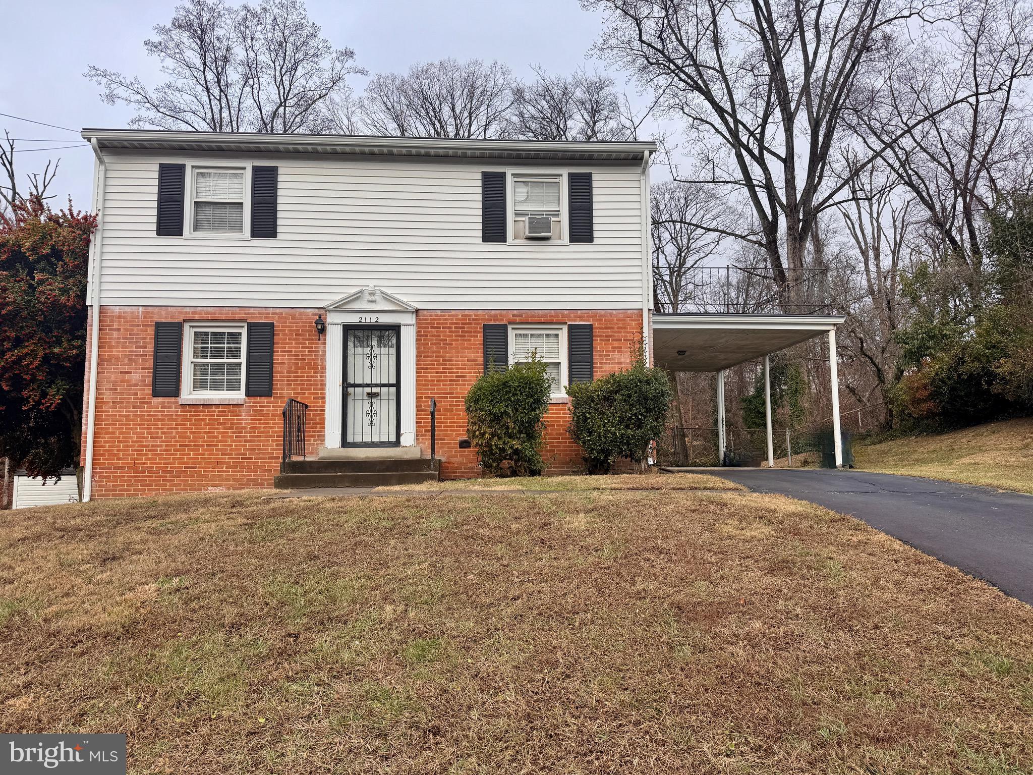 2112 Patrick Street Woodbridge, VA 22191 - Photo 6 of 65 a front view of a house with a yard and garage