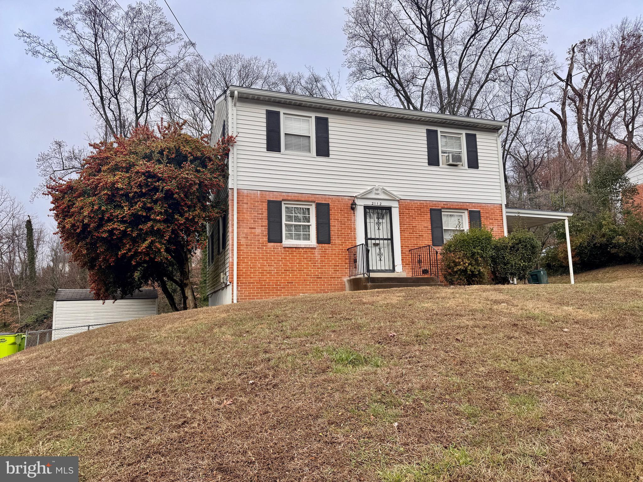 2112 Patrick Street Woodbridge, VA 22191 - Photo 7 of 65 a front view of a house with a yard and garage