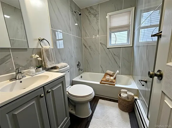 a bathroom with a sink toilet bathtub and vanity