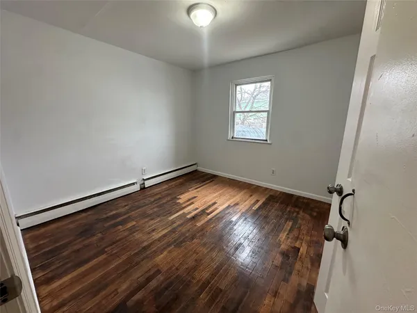 a view of room with window and hardwood floor