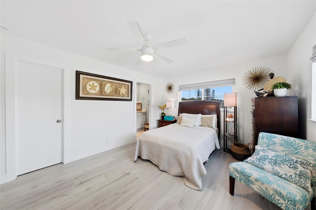 1450 North Riverside Drive, Unit 201 Pompano Beach, FL 33062 - Photo 12 of 30 a spacious bedroom with two beds and painting on the wall