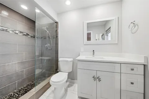 a bathroom with a sink mirror toilet and shower