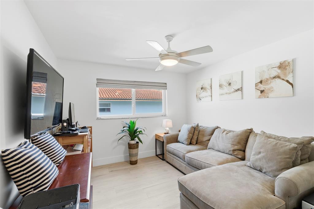 1450 North Riverside Drive, Unit 201 Pompano Beach, FL 33062 - Photo 14 of 30 a living room with furniture and a chandelier