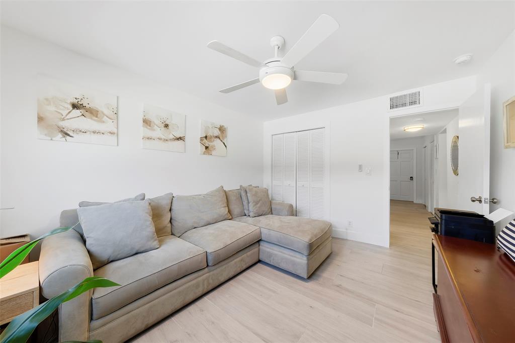 1450 North Riverside Drive, Unit 201 Pompano Beach, FL 33062 - Photo 15 of 30 a living room with furniture and a wooden floor