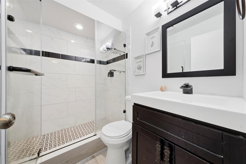 1450 North Riverside Drive, Unit 201 Pompano Beach, FL 33062 - Photo 16 of 30 a bathroom with a sink a toilet a mirror and shower