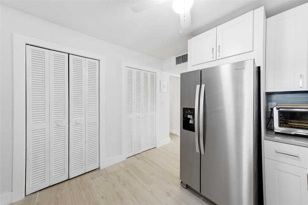 1450 North Riverside Drive, Unit 201 Pompano Beach, FL 33062 - Photo 20 of 30 a view of a kitchen with refrigerator and cabinet