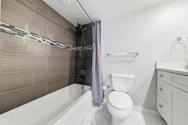 a bathroom with a toilet and a bathtub