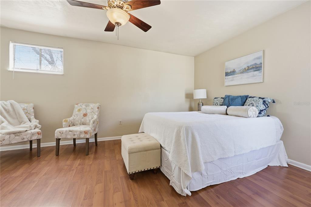 4427 Southwest 21st Lane Gainesville, FL 32607 - Photo 16 of 36 a bedroom with a bed and wooden floor