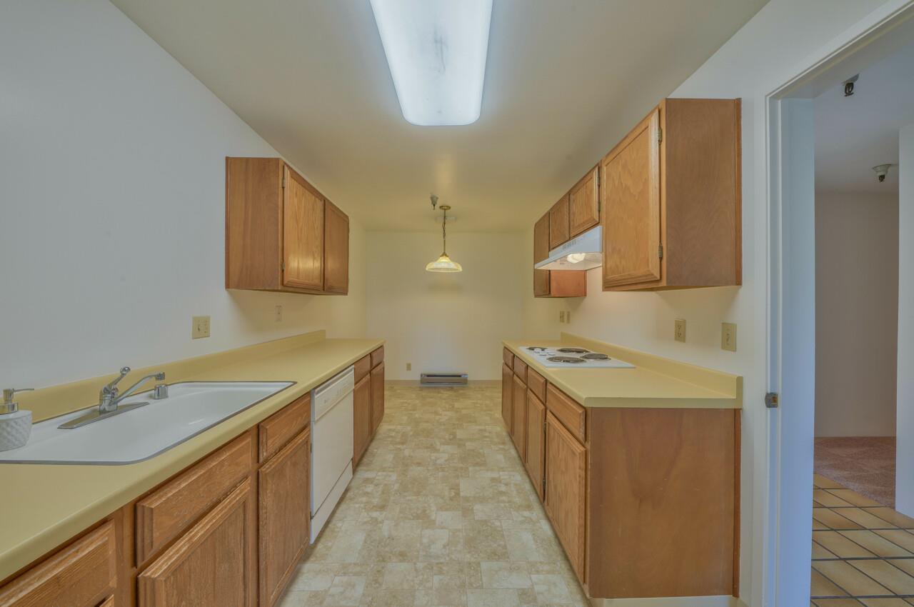 18 Shepherds Knoll Road Monterey, CA 93940 - Photo 12 of 28 a kitchen with a sink stove and cabinets