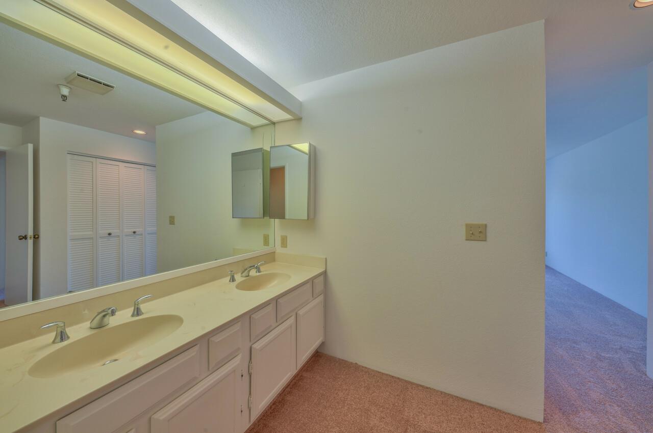18 Shepherds Knoll Road Monterey, CA 93940 - Photo 20 of 28 a bathroom with a double vanity sink and mirror