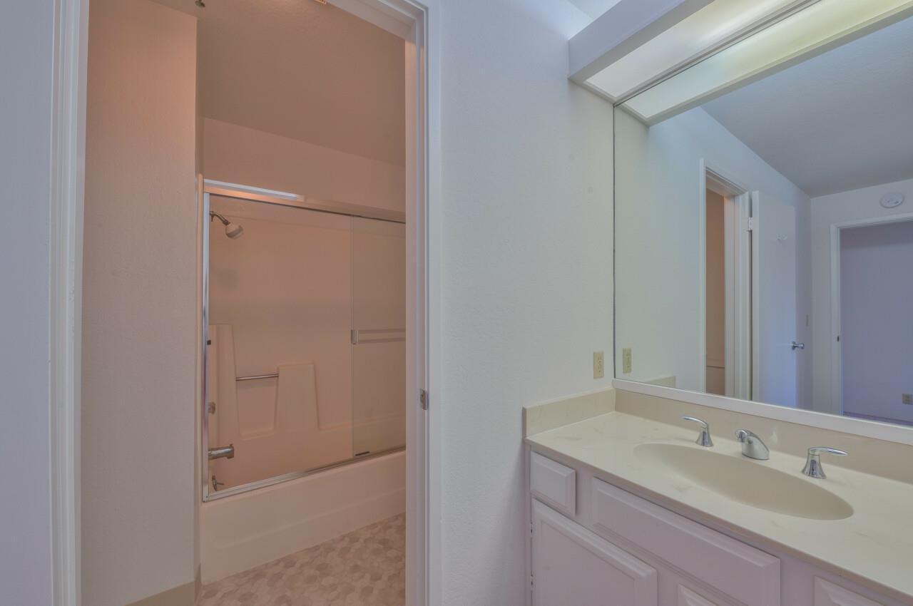 18 Shepherds Knoll Road Monterey, CA 93940 - Photo 21 of 28 a bathroom with a granite countertop sink and mirror