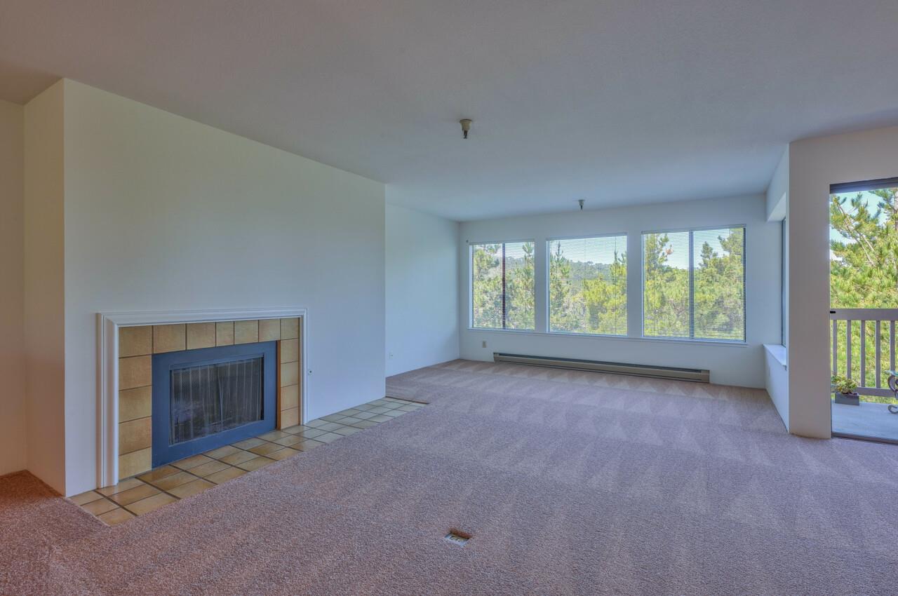 18 Shepherds Knoll Road Monterey, CA 93940 - Photo 4 of 28 a view of an empty room with a window and fireplace
