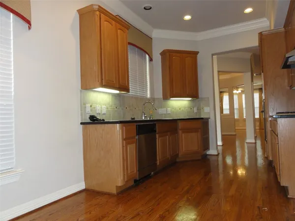 a kitchen with granite countertop wooden cabinets and a granite counter tops