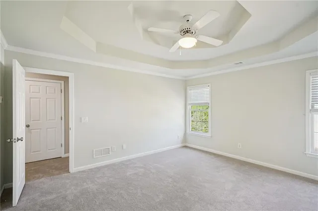 an empty room with fan and windows