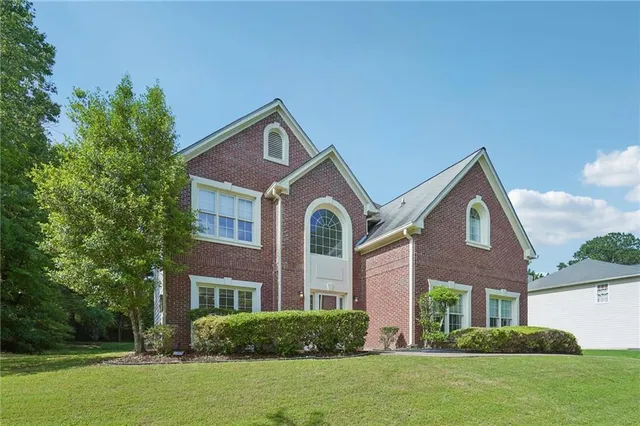 a front view of a house with a yard