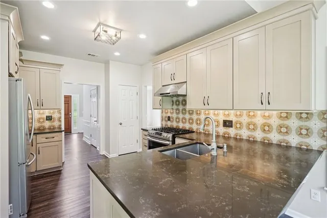 a living room with stainless steel appliances kitchen island granite countertop furniture and a kitchen view