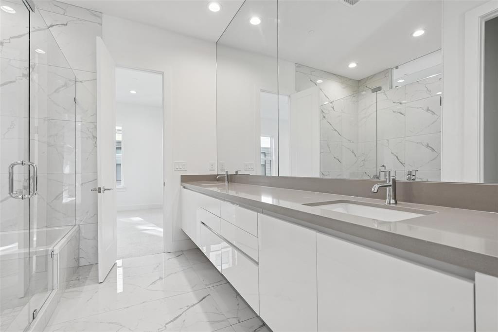 3040 ChImes Street Dallas, TX 75219 - Photo 18 of 38 a bathroom with a granite countertop sink mirror and a shower