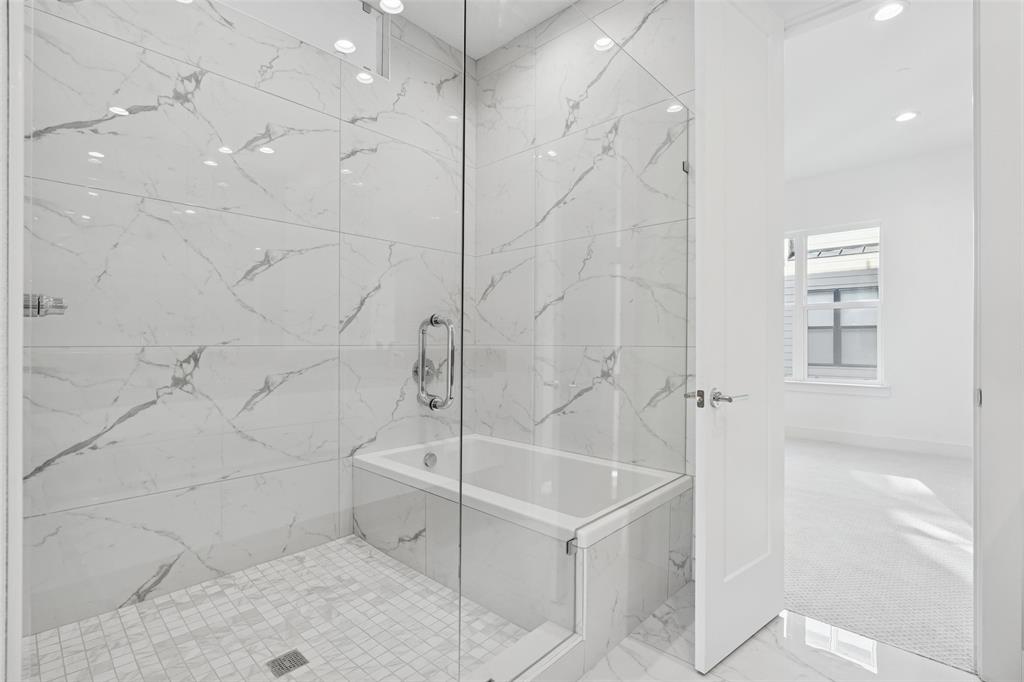 3040 ChImes Street Dallas, TX 75219 - Photo 19 of 38 a bathroom with a bathtub and a shower