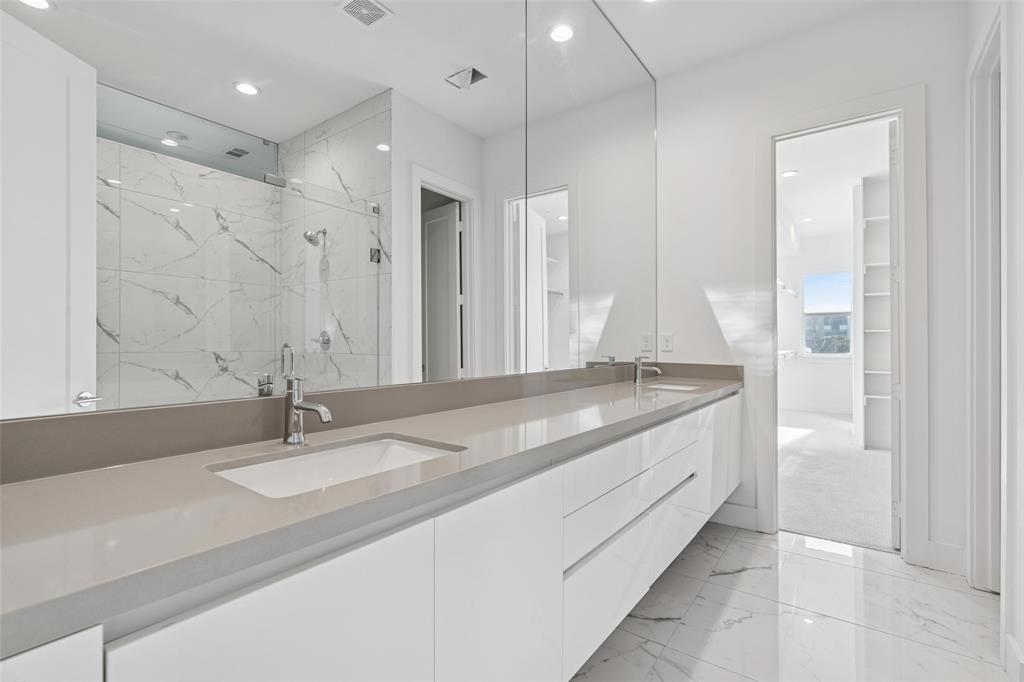 3040 ChImes Street Dallas, TX 75219 - Photo 20 of 38 a bathroom with a sink double vanity and a mirror