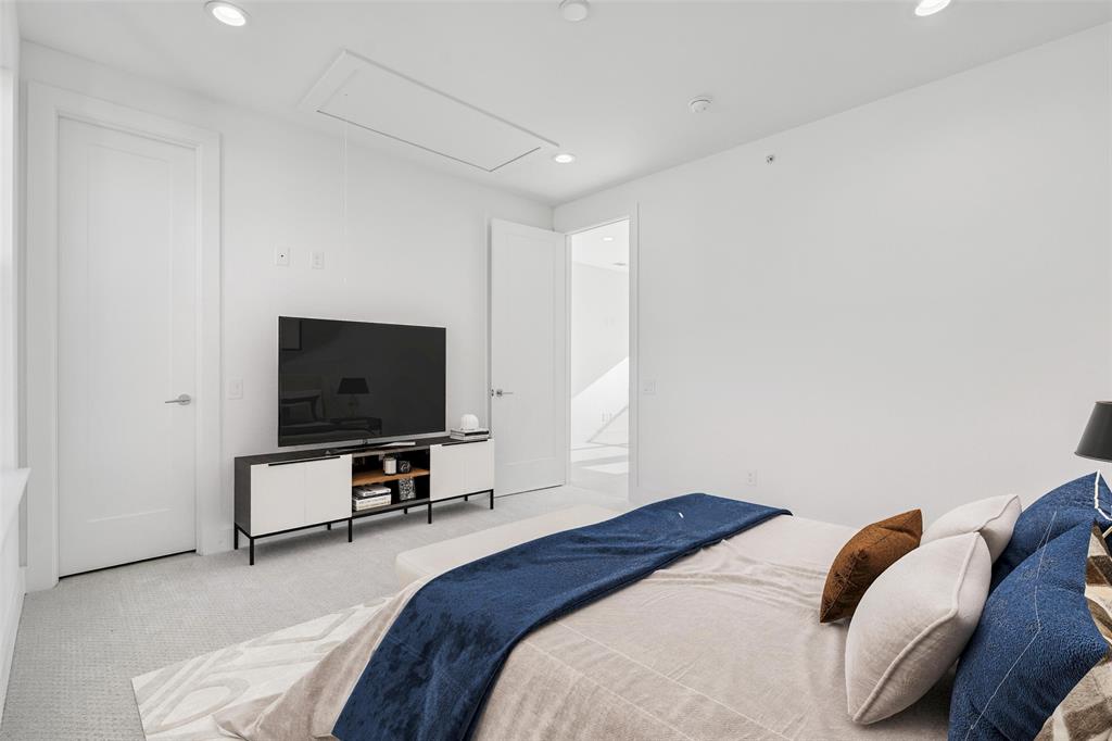3040 ChImes Street Dallas, TX 75219 - Photo 25 of 38 a bedroom with a bed and a flat screen tv