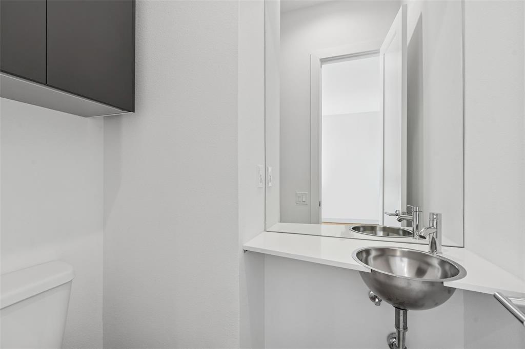 3040 ChImes Street Dallas, TX 75219 - Photo 30 of 38 a bathroom with a sink and a mirror