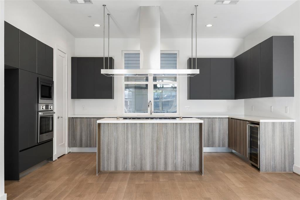 3040 ChImes Street Dallas, TX 75219 - Photo 9 of 38 a kitchen with stainless steel appliances granite countertop a stove a refrigerator and a microwave