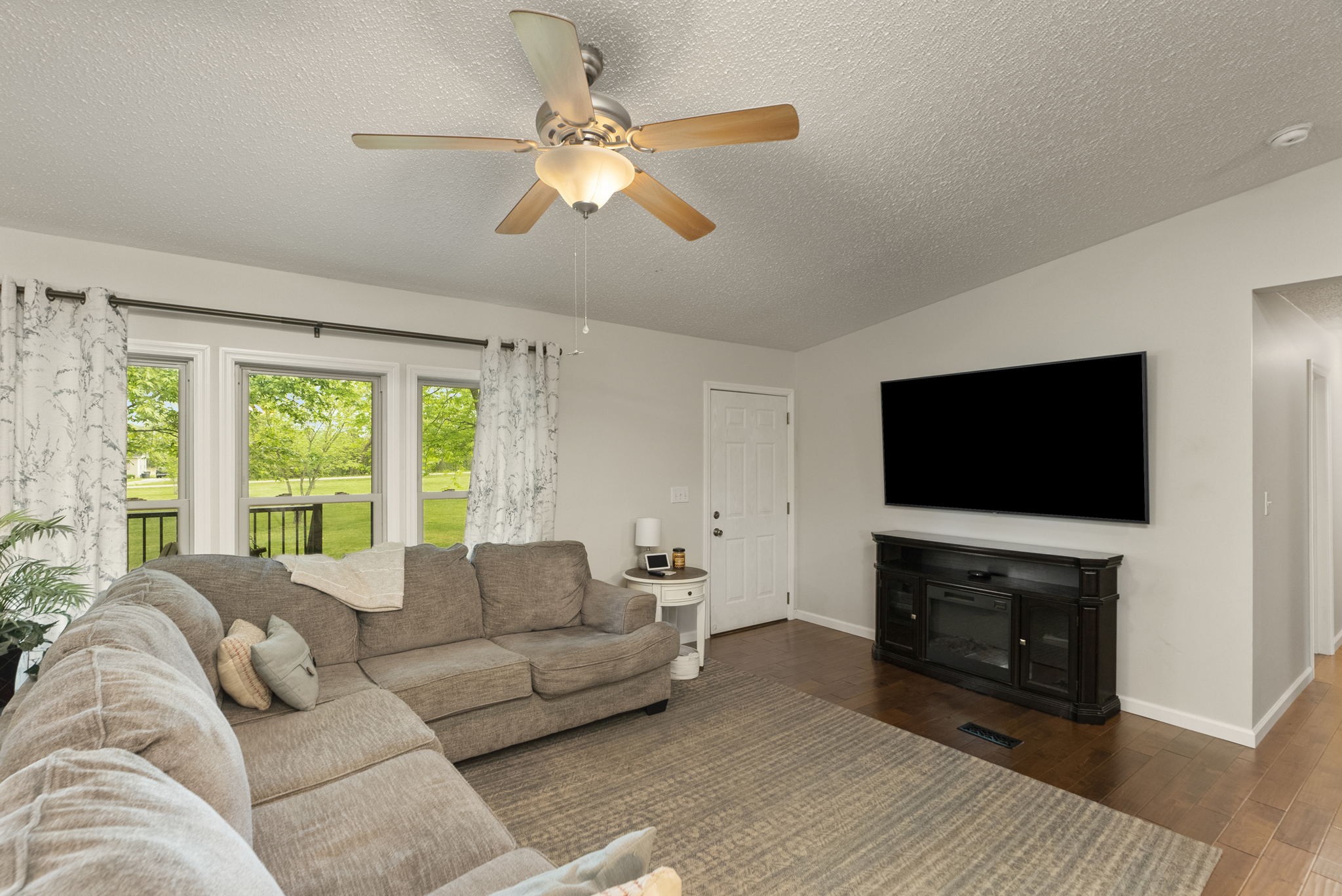 843 North Corinth Road Portland, TN 37148 - Photo 13 of 52 a living room with furniture a flat screen tv and a fireplace