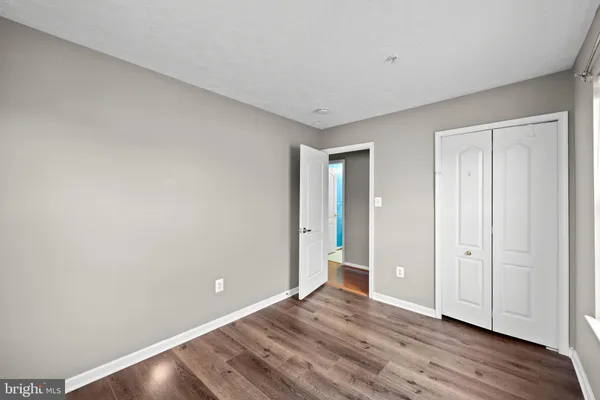 a view of an empty room and wooden floor