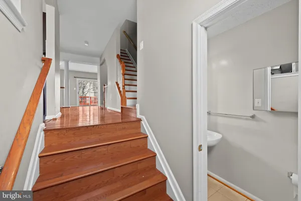 a view of entryway and hall with wooden floor