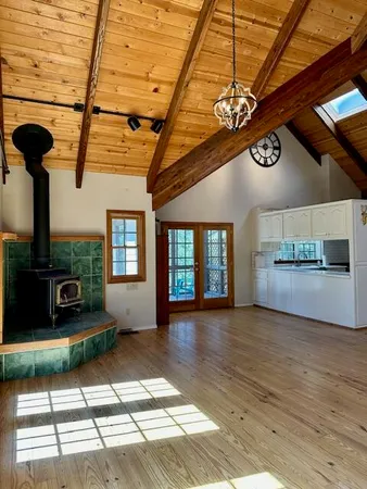 a view of porch with a floor to ceiling window and wooden floor
