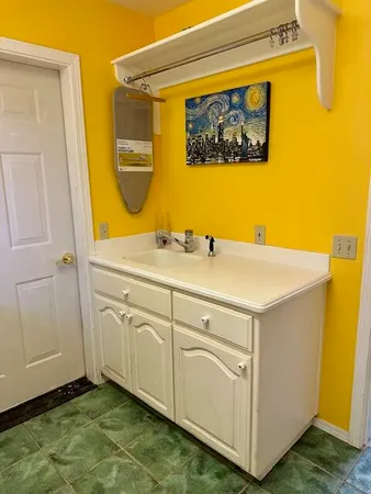 a bathroom with a toilet a sink and mirror