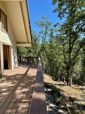 a balcony with wooden floor and fence