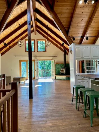 a view of a room with wooden floor