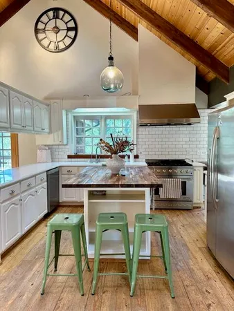 a kitchen with a stove a sink and a cabinets