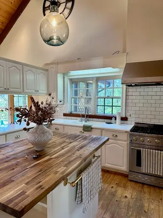 a stove top oven sitting inside of a kitchen