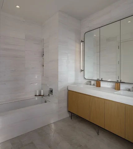 a bathroom with a double vanity sink and mirror
