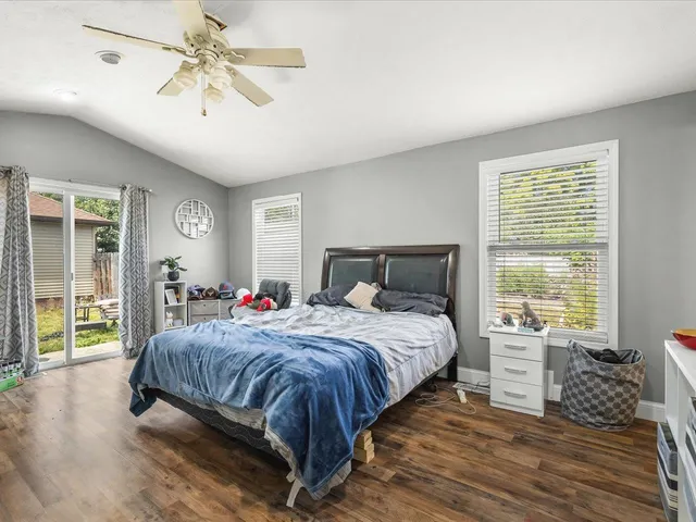 a bedroom with furniture and a flat screen tv