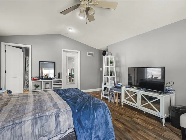 a bathroom with a sink a toilet and shower curtain