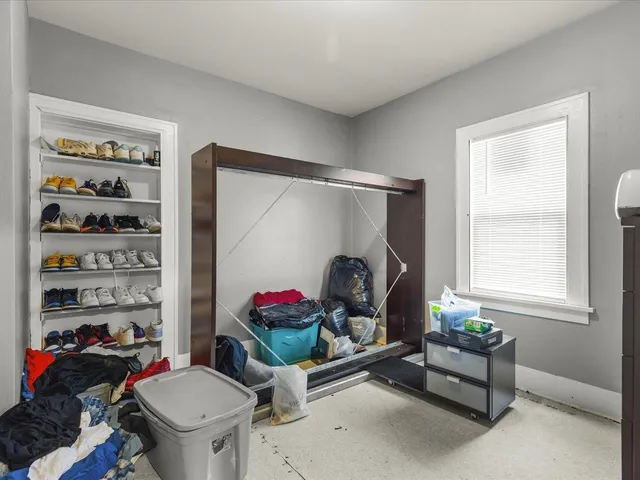 a bedroom with furniture and a chandelier