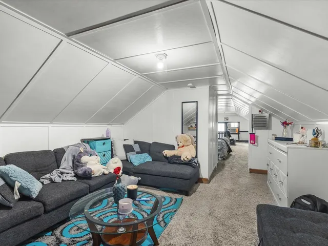 a bed room with a bed and a chair