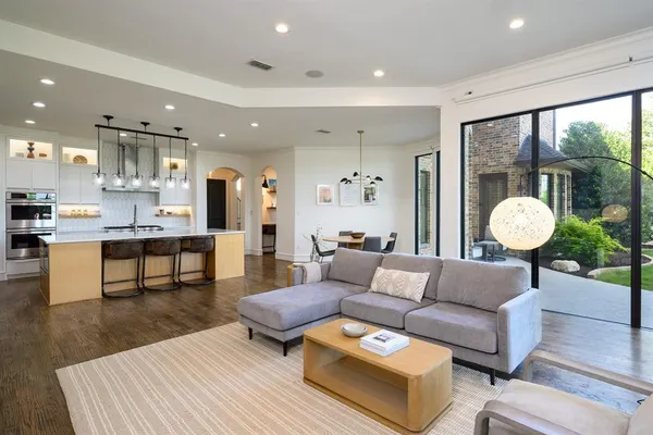 a living room with furniture and a book shelf