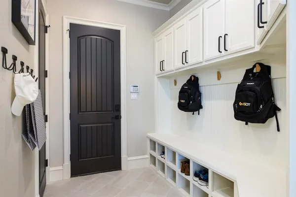 a kitchen with stainless steel appliances a sink a refrigerator and cabinets