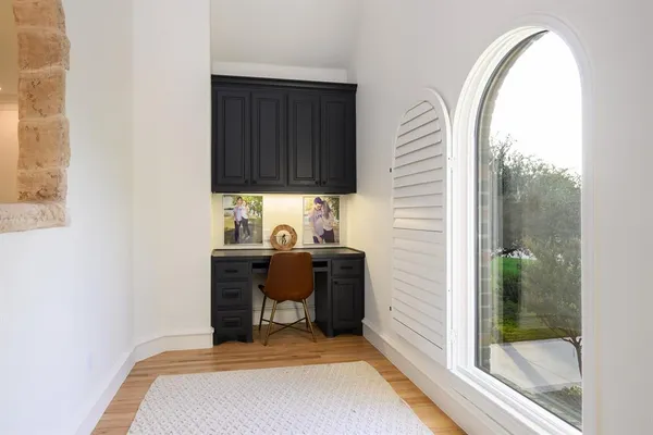 a bathroom with a granite countertop sink a toilet a mirror and shower
