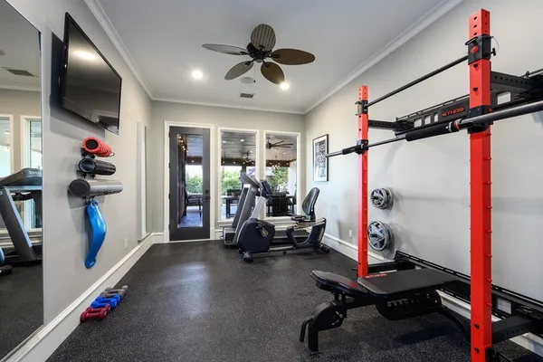 a bedroom with a bed and ceiling fan