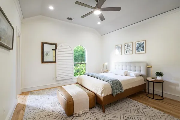 a patio with couches and a dining table with garden view